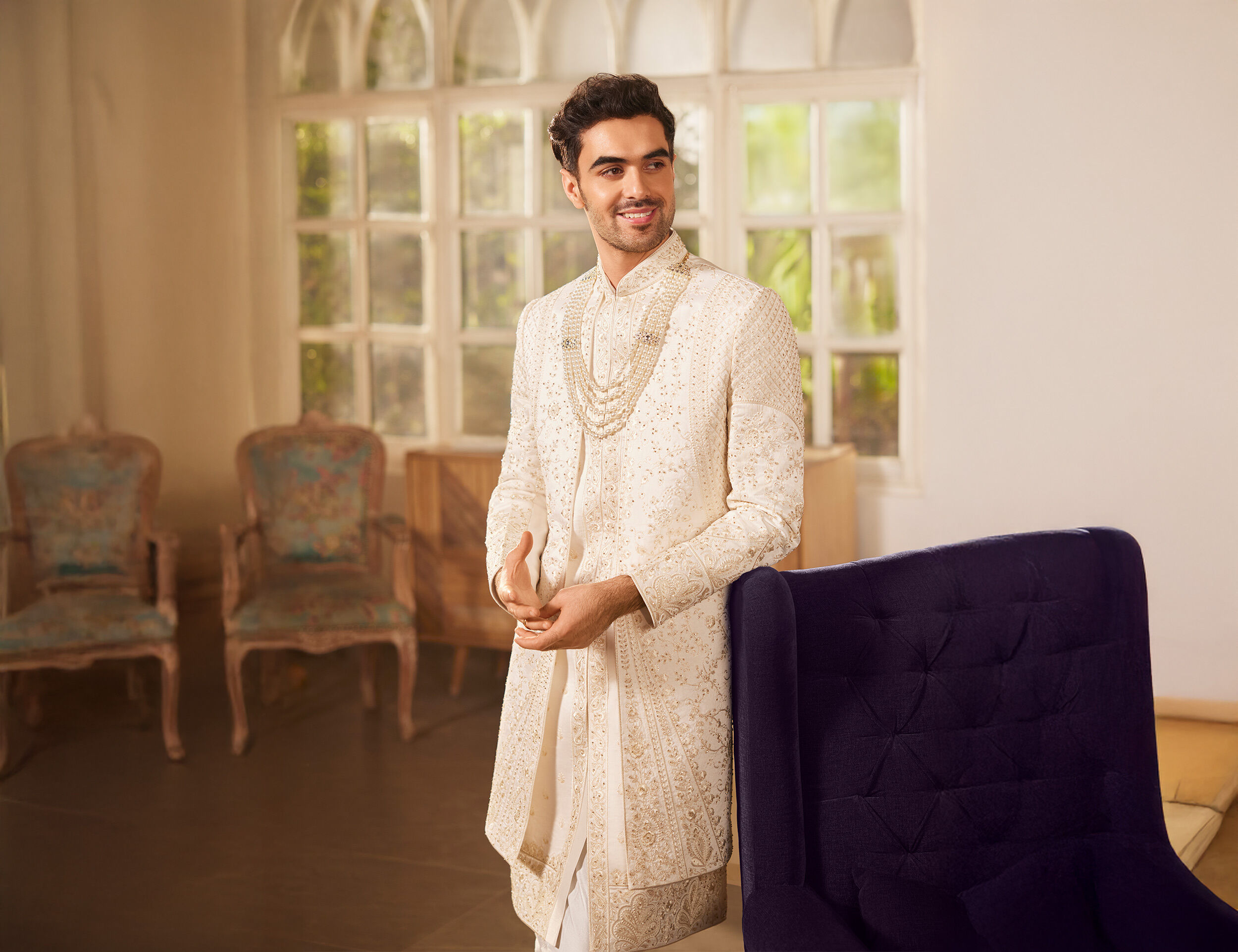 Groom flaunting his beautiful wedding sherwani with mala 